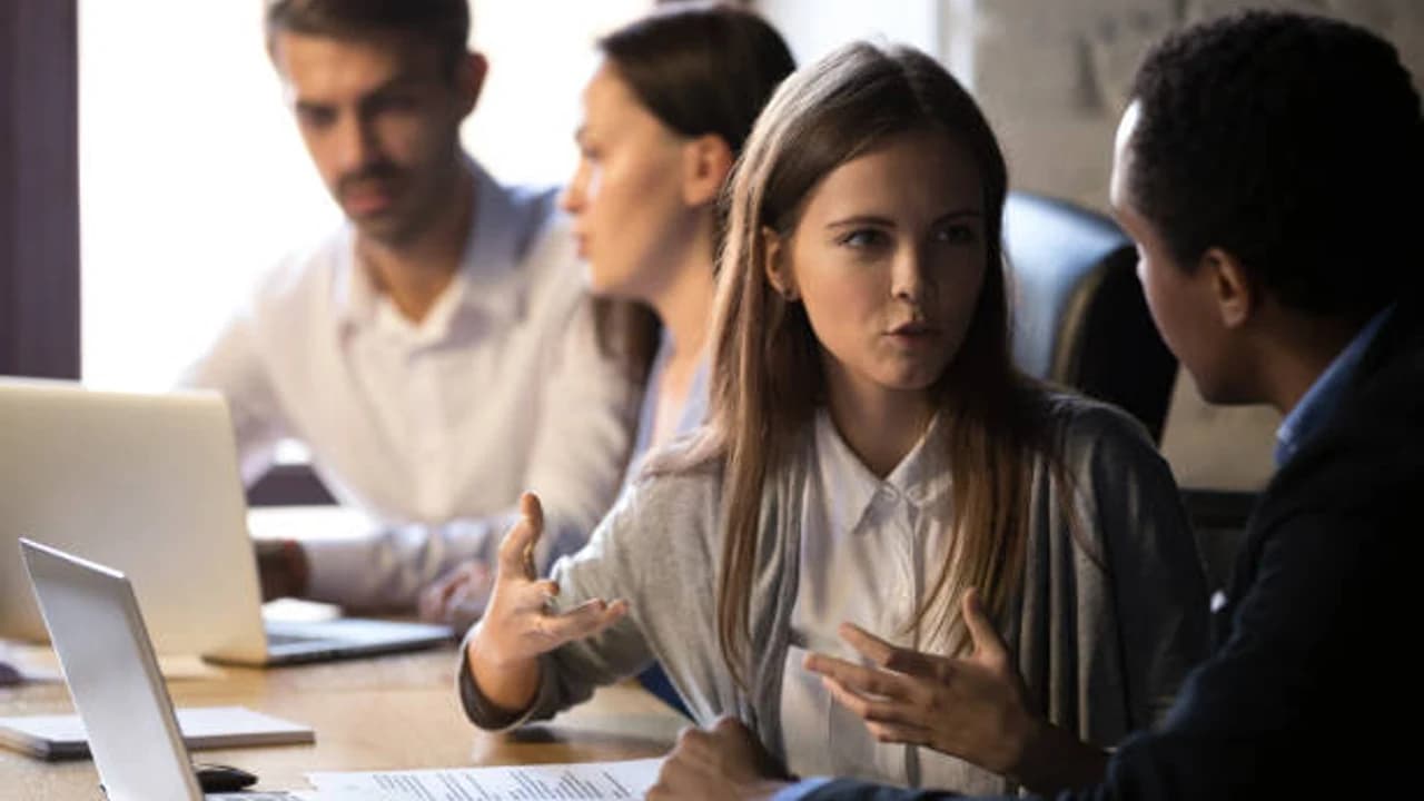 Enterprise conflict resolution: two parties in a boardroom negotiation with a neutral mediator